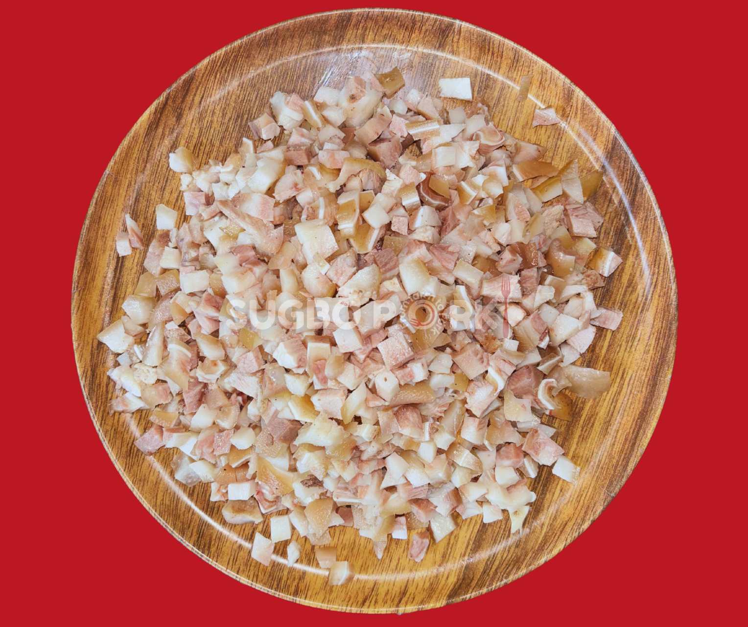 Professional product photography showing cubed pork sisig cuts on wooden circular plate with fresh texture and color, featuring Sugbo Pork watermark against vibrant red background